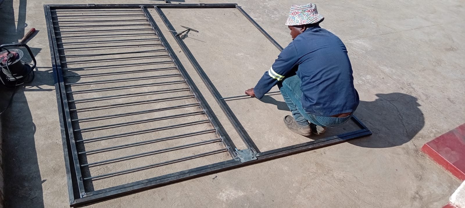 Xolile Makunyane fabricating a steel gate