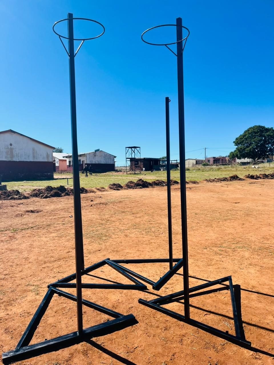 Steel netball posts on a school sports field