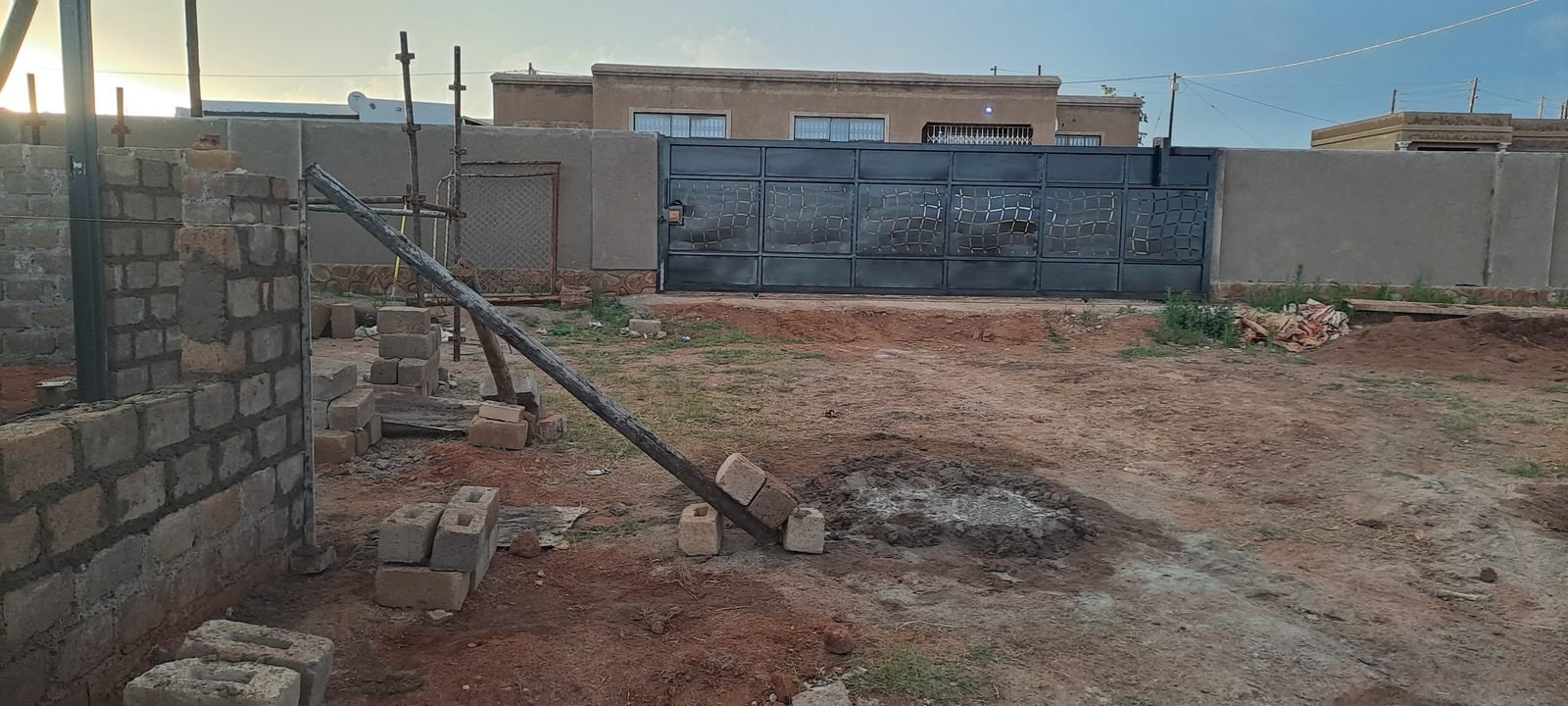 Sliding gate with patterned steel infill panel