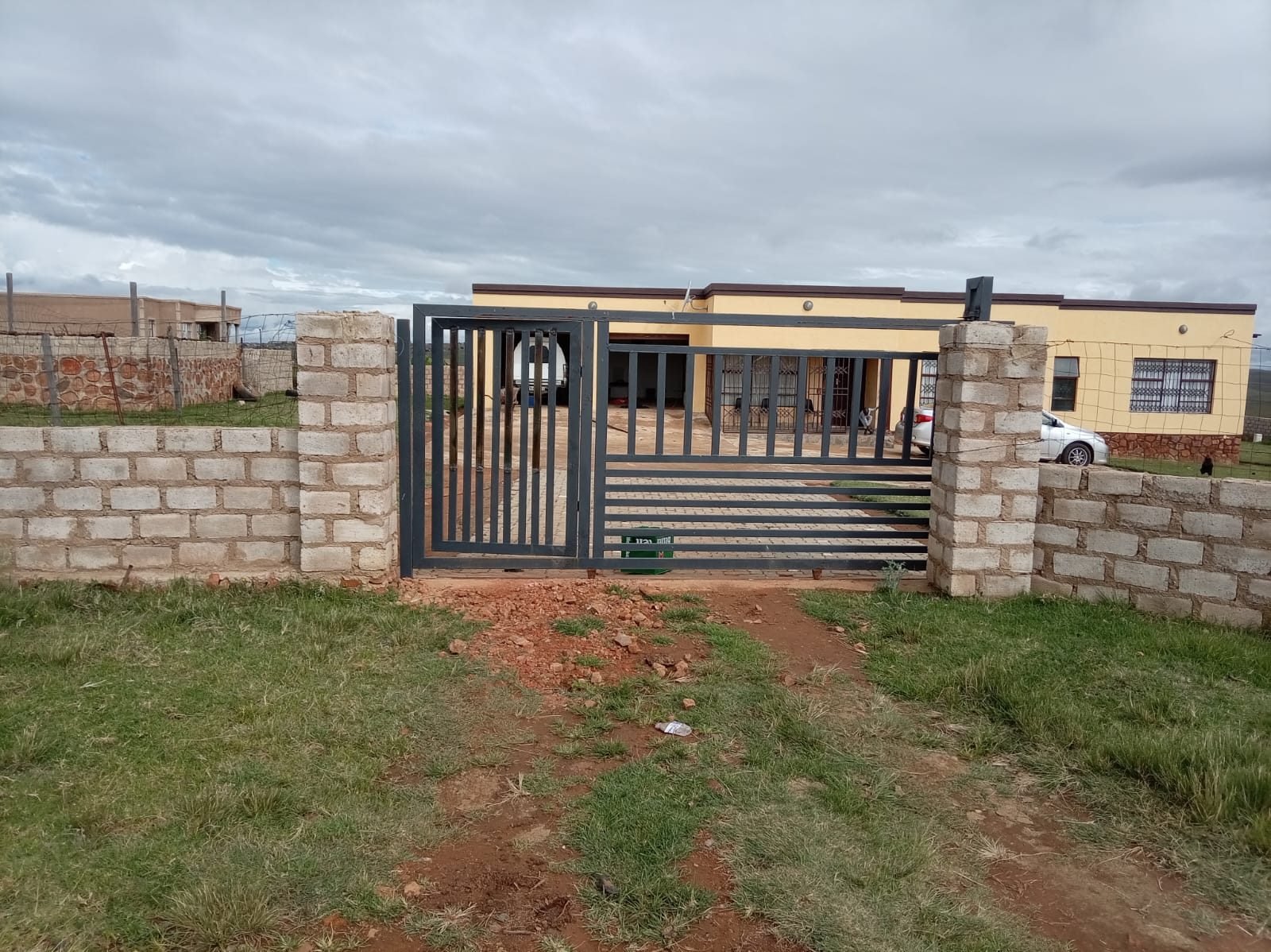 Sliding driveway gate with matching pedestrian gate
